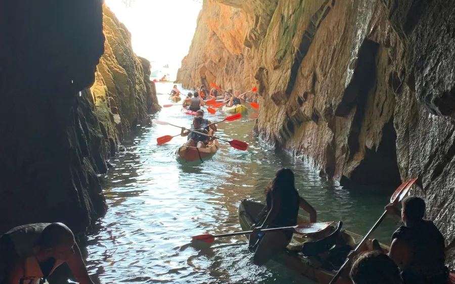 Kayakers in a narrow passage between high rock walls