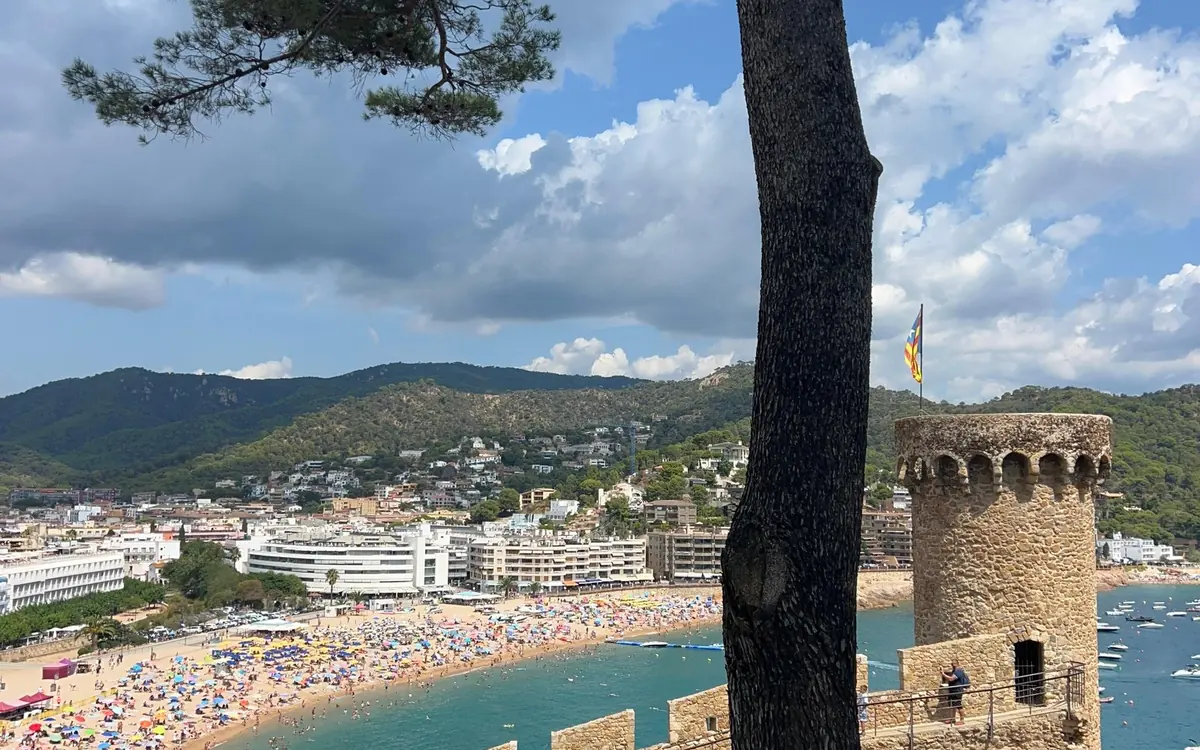 A medieval stone tower on the headland above the beach at Tossa de Mar